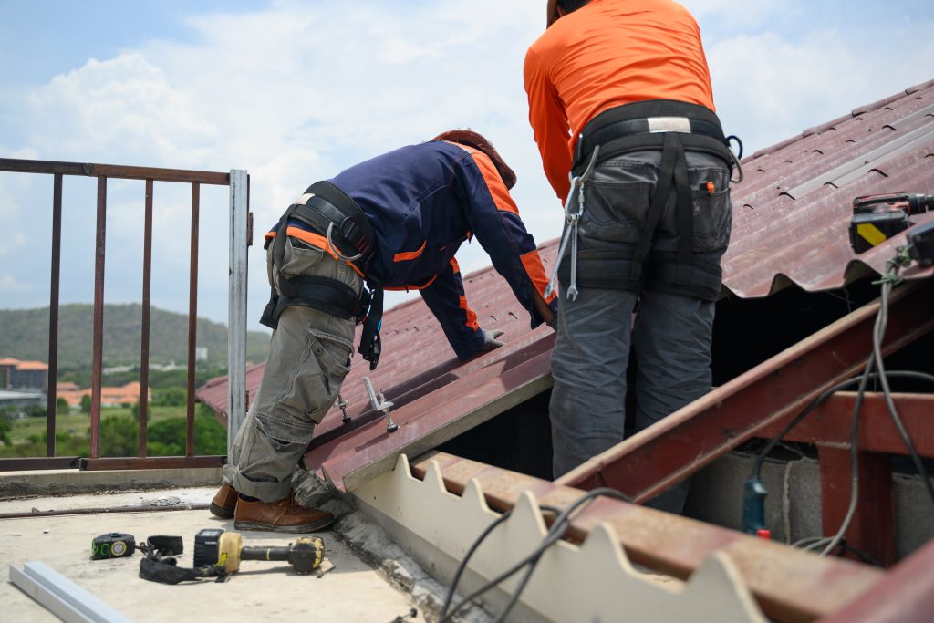Professional engineer worker installing solar panels system on rooftop, Clean energy sources, Concept of alternative and renewable energy, Environment and technology concept